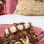 A close-up, high-quality image of a dessert featuring melted chocolate and cream, topped with a Kinder chocolate bar, served on a pink plate.