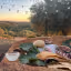 An inviting outdoor dining setup featuring a rustic table with food and a drink bowl, set against a stunning sunset landscape with rolling hills, olive trees, and string lights overhead.