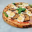 An overhead shot of a round pizza topped with sliced hard-boiled eggs, roasted eggplant, and fresh basil leaves, resting on a light-colored surface.